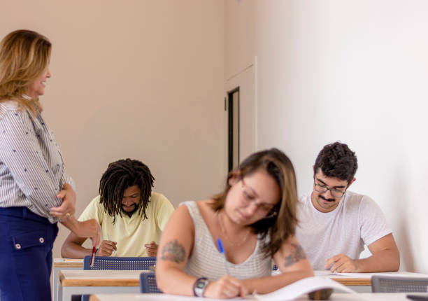 istock Brazilian university students taking school exams with the teacher beside them 1209487188