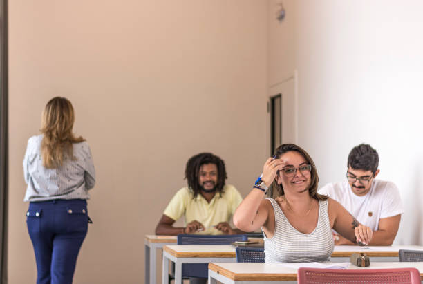 istock Brazilian university students taking school exams with the teacher beside them 1209487220
