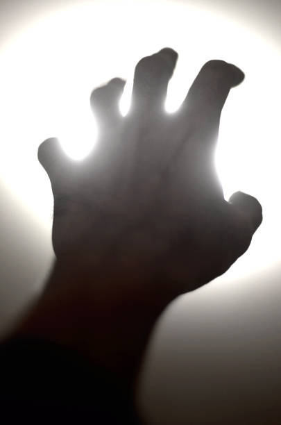 istock Silhouette of human hand reaching out to light, Need help concept 1209487962