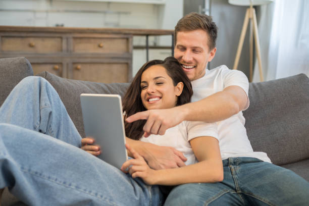 istock Smiling young couple having rest at home 1209488286