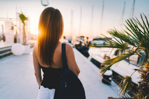 istock Woman at the marina staring the sunset 1209488520