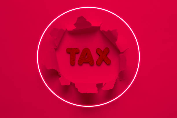 istock Word tax in a torn hole with neon glow circle. Pink light. Top view 1209488859