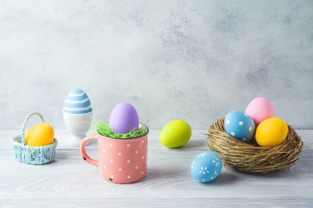 istock Easter holiday decorations with easter eggs and bird nest on wooden table 1209491249
