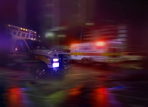 An ambulance speeding through traffic at nighttime An ambulance speeding through traffic at nighttime air attack photos stock pictures, royalty-free photos & images