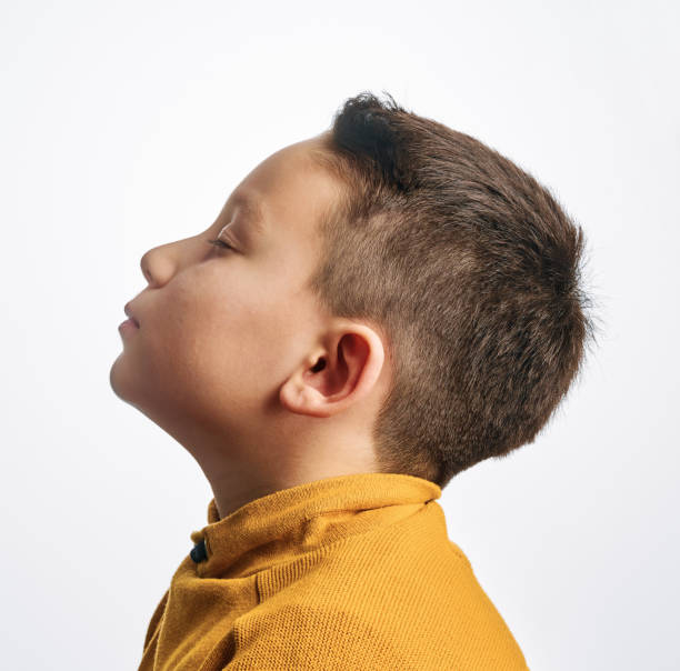 istock Portrait of 6-7 years old cute handsome child on white background. 1209499708