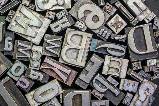background of random vintage grunge letterpress metal type printing blocks