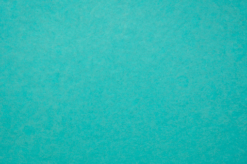 background and texture of teal blue handmade Indian paper created from recycled cotton fabric