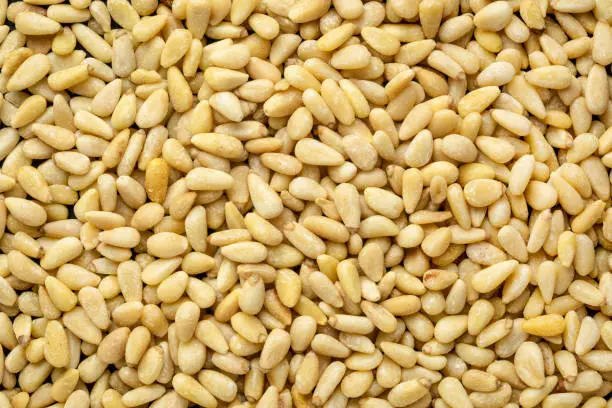 closeup background of shelled pine nuts, top view