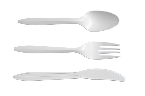 Spoon, knife and fork isolated on a white background, top view. Disposable tableware