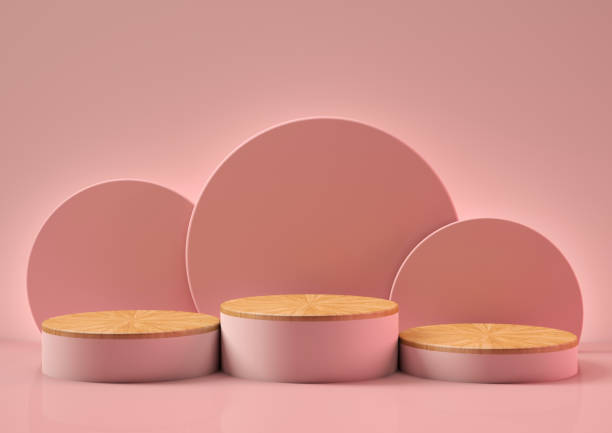 3D set of three pink podiums with a wooden base on pink background stock photo