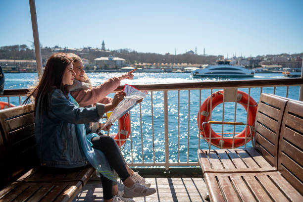 Woman Friends looking at map in ship at Istanbul Scenes in Istanbul passenger ship stock pictures, royalty-free photos & images