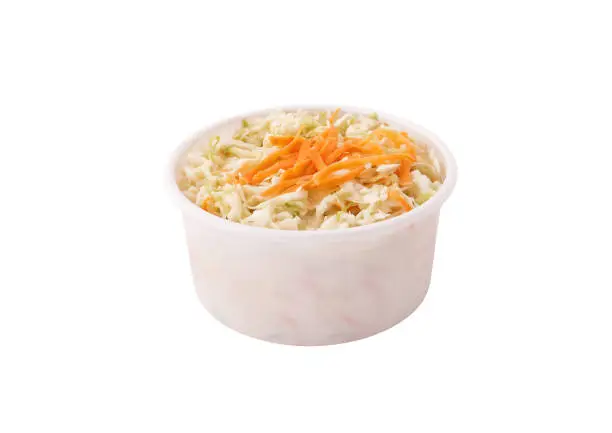 Coleslaw salad in plastic container bowl isolated on white background