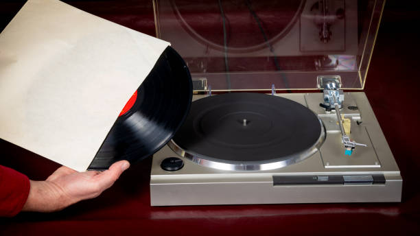 istock Vinyl record is removed from the jacket with turntable 1209514503
