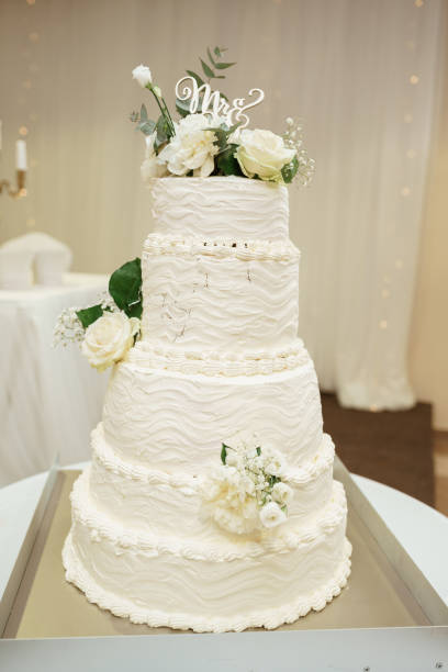 istock luxury Beautiful wedding white cake with white roses at wedding reception. wedding day 1209517454