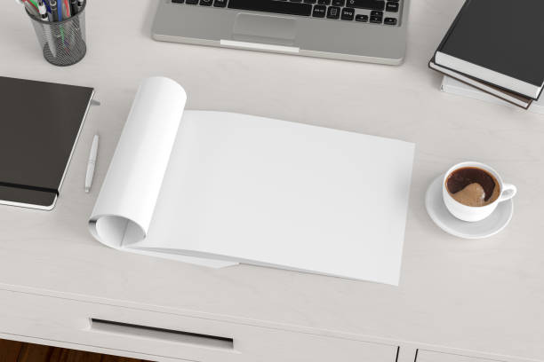 istock Blank magazine page. Workspace with folded magazine mock up on the desk. 1209517736