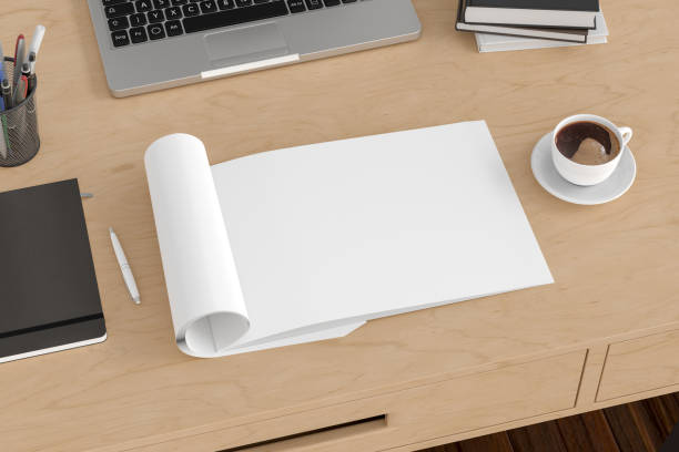 istock Blank magazine page. Workspace with folded magazine mock up on the desk. 1209517748