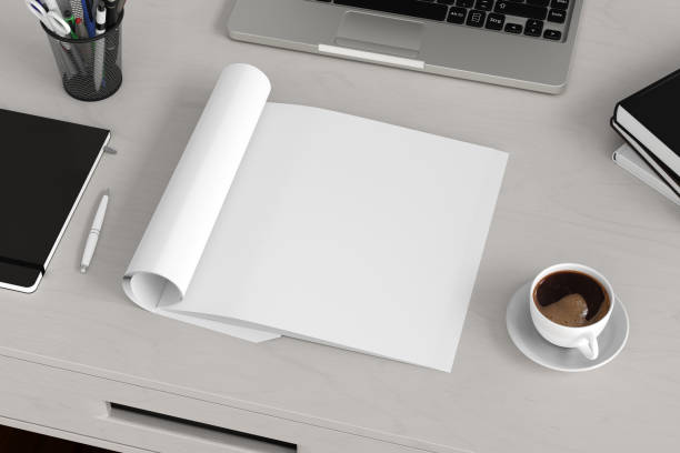 istock Blank magazine page. Workspace with folded magazine mock up on the desk. 1209517757