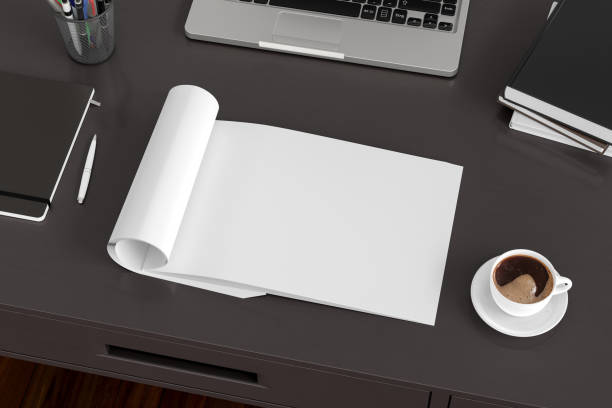 istock Blank magazine page. Workspace with folded magazine mock up on the desk. 1209517777