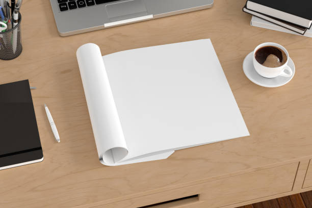 istock Blank magazine page. Workspace with folded magazine mock up on the desk. 1209517797