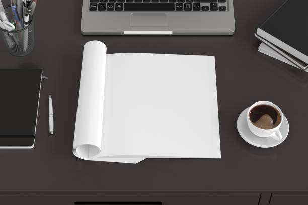 istock Blank magazine page. Workspace with folded magazine mock up on the desk. 1209517807