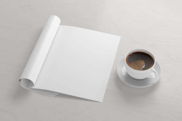 istock Blank magazine page. Workspace with folded magazine mock up on the desk. 1209517824