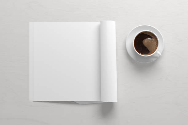 istock Blank magazine page. Workspace with folded magazine mock up on the desk. 1209517861