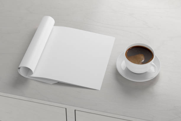 istock Blank magazine page. Workspace with folded magazine mock up on the desk. 1209517962