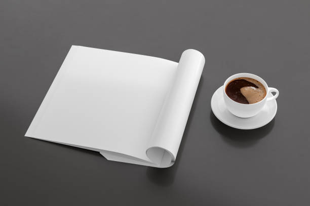istock Blank magazine page. Workspace with folded magazine mock up on the desk. 1209517977