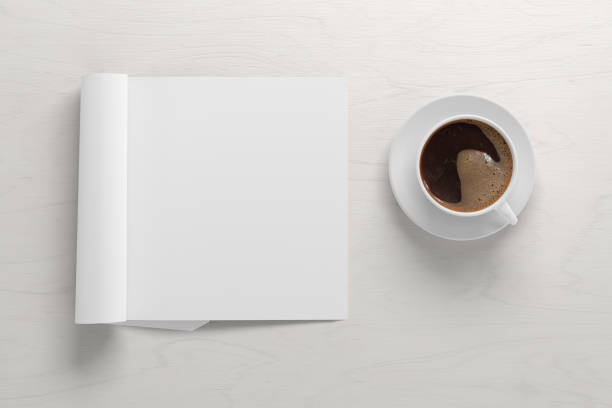 istock Blank magazine page. Workspace with folded magazine mock up on the desk. 1209518487