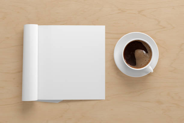 istock Blank magazine page. Workspace with folded magazine mock up on the desk. 1209518512