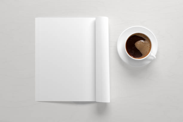 istock Blank magazine page. Workspace with folded magazine mock up on the desk. 1209518541