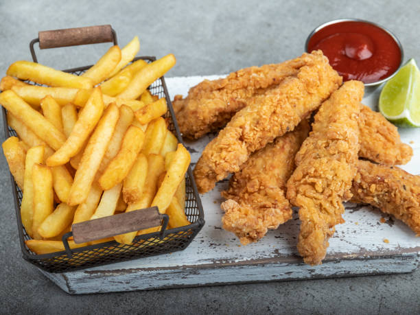 istock crispy fried breaded chicken breast strips french fries and sauce 1209524174