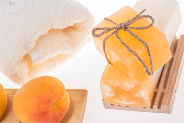natural soap bars, apricots and towel on white stock photo