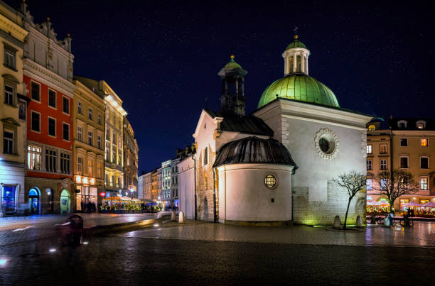 Night view of romanesque church of St. Adalbert and the Main Market Square, Krakow, Poland