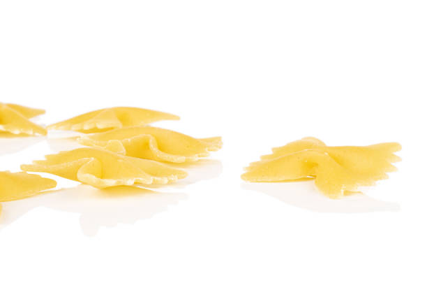 istock Yellow farfalle pasta isolated on white 1209528548