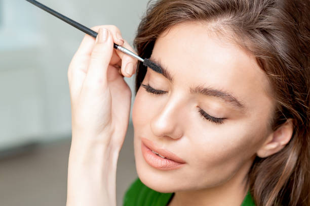 istock Woman with eyebrow brush tool 1209529479