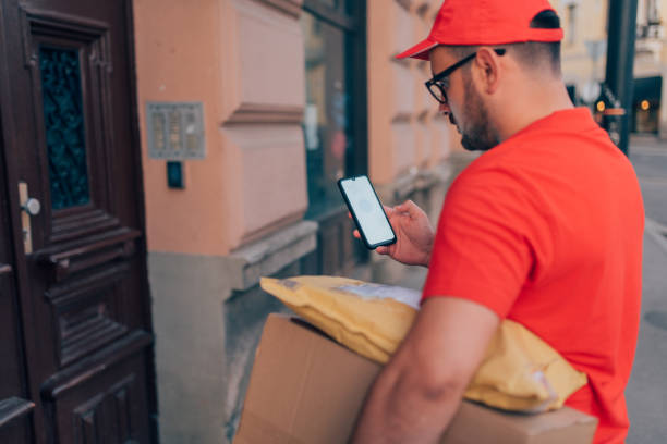 istock Delivery person using a mobile phone 1209529927