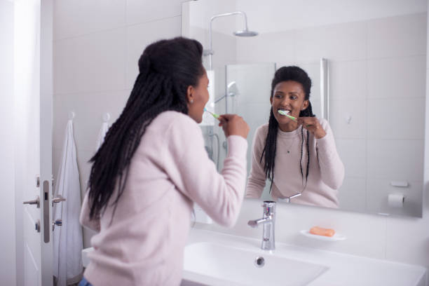 istock Woman brushing her teeth in the shower room. 1209530510
