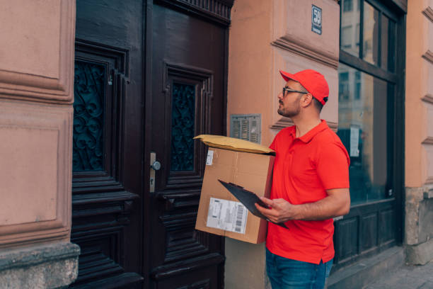 istock Delivery man looking for the address 1209530775
