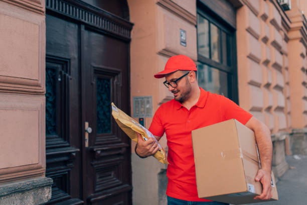istock Delivery person checking for additional information 1209530790
