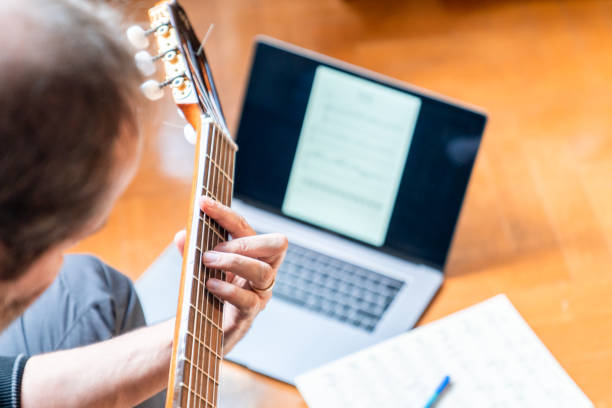 istock Seniors man are playing a guitar at home. Retired man learning playing a guitar. 1209535590