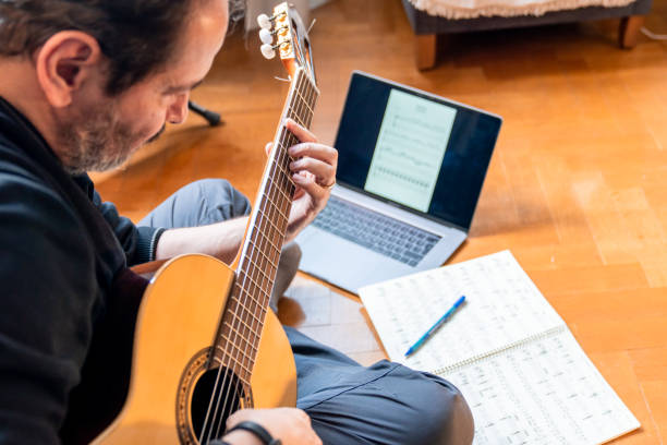 istock Seniors man are playing a guitar at home. Retired man learning playing a guitar. 1209535698