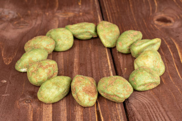 istock Green wasabi peanut on brown wood 1209537291