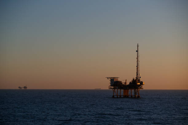 istock Offshore oil rig at sunset 1209542101