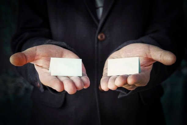 hands is holding a blue color papers with empty space for note. Offer choice of 2 options.
