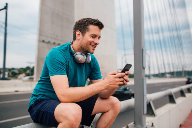 istock Young man sitting and using the phone 1209552418