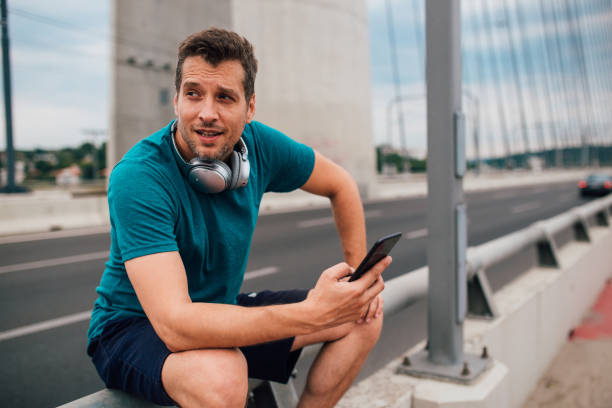 istock Handsome man sitting on the fence 1209552422