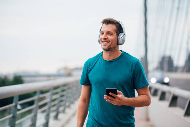 istock Man walking with headphones 1209552423