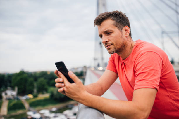 istock Handsome man wearing orange T-shirt 1209552449