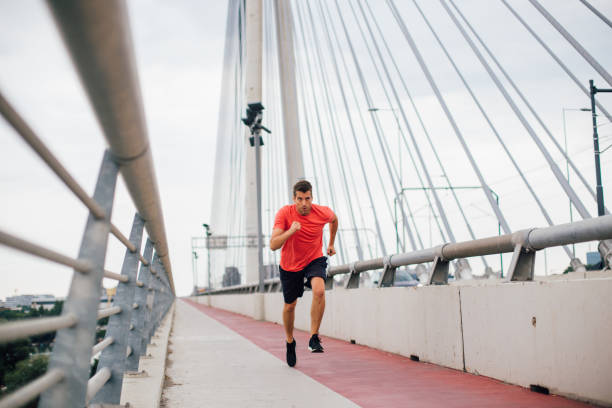 istock Sportsman running on the bridge 1209552453
